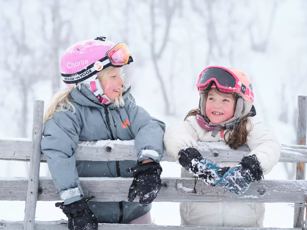 Girls hanging on the wooden fence in the mountain Visit Norway Matias Fosso Kristiansen