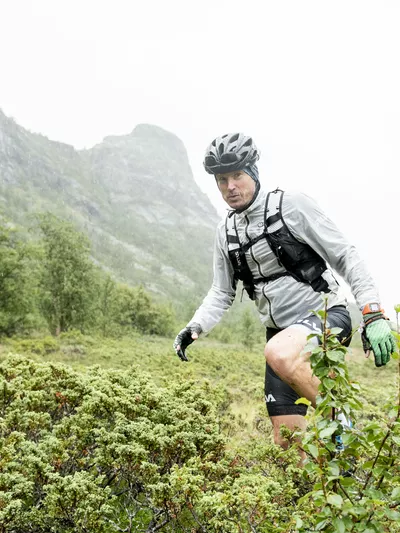 To mennesker som går i fjellet med sykkelhjelm