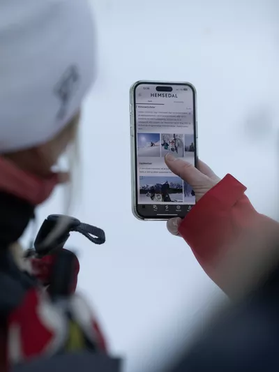 To personer som ser på Hemsedal appen vinterstid
